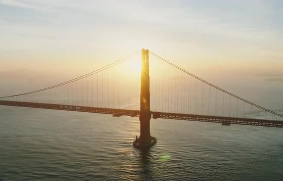 Medium aerial shot of golden gate bridge at sunrise