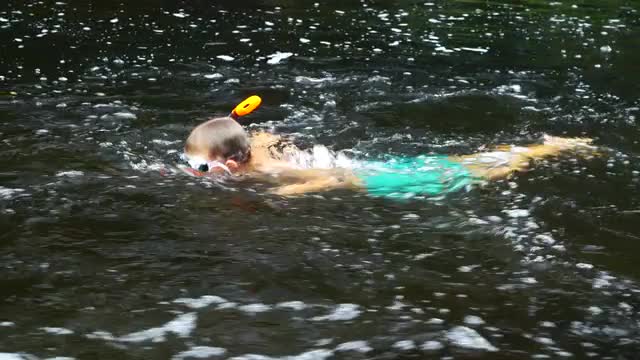 boy snorkeling in streaming water