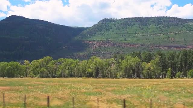 Slow motion pov driving vehicle shot on Gunnison farm field in Montrose Colorado