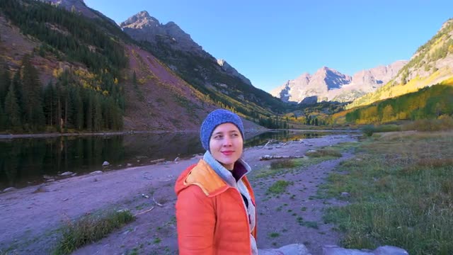 Maroon Bells Aspen, Colorado autumn fall pov of woman walking sunrise