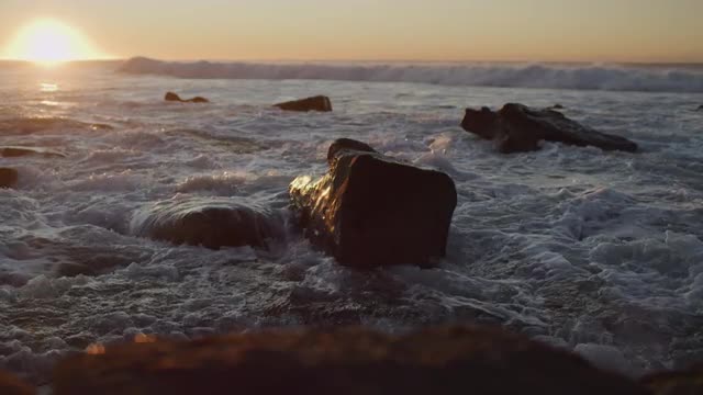 Waves and seafoam coming towards camera in sunrise Merewether Beach