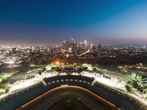 Aerial Hyperlapse of Dodgers Stadium with Downtown Los Angeles at blue hour