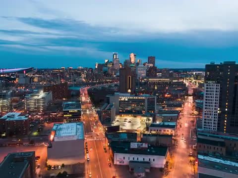 Aerial Hyperlapse over Minneapolis Skyline, Blue Hour over X Cross Walk in Road, Dolly In Low
