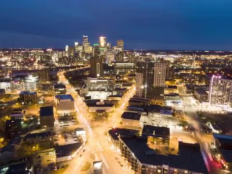 Aerial Hyperlapse over Minneapolis Skyline, Blue Hour over X Cross Walk in Road, Dolly In High