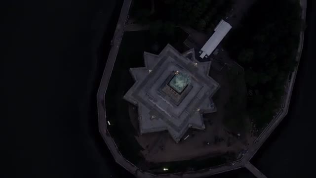 AERIAL WIDE TILT DOWN view of the Statue of Liberty
