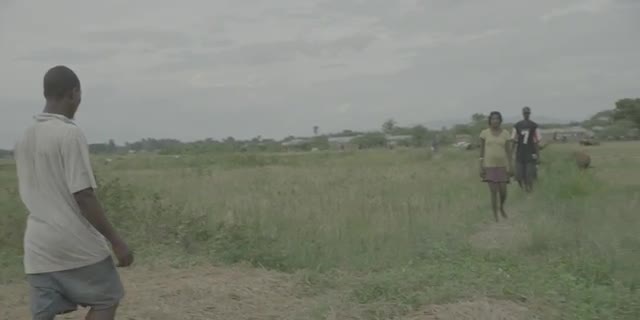 Haitian Man Hauls Grain on Motorcycle