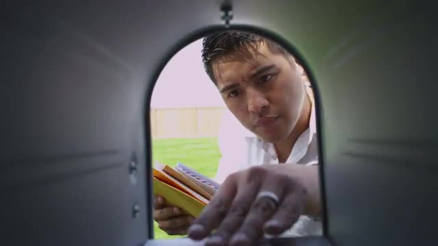 Man opens mailbox and gets letters