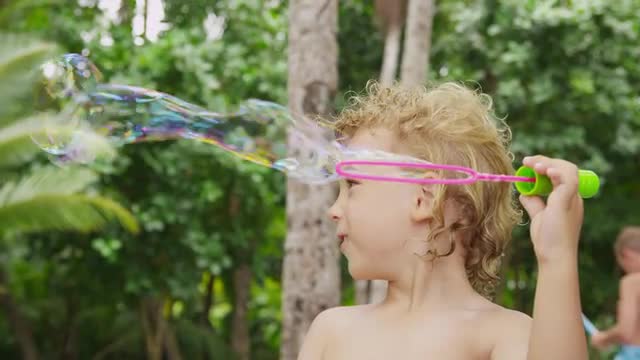 Young boy playing with bubbles
