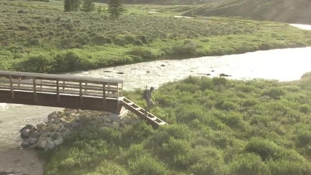 CineFlex Hiker Crossing Bridge