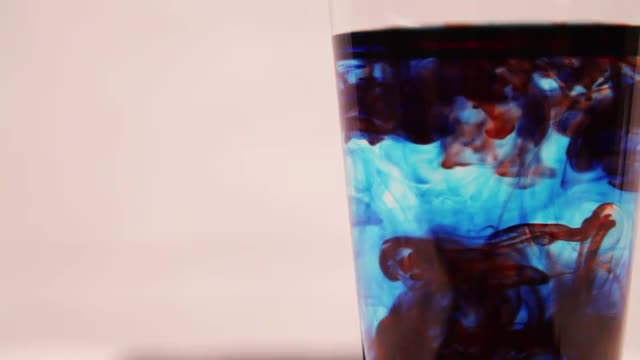 Red color droplets in blue liquid