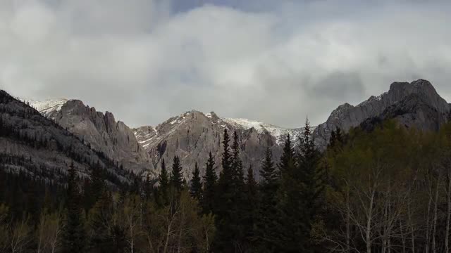 Moving clouds with shadow on mountain