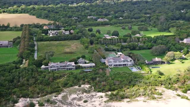 WIDE AERIAL mansions on coast