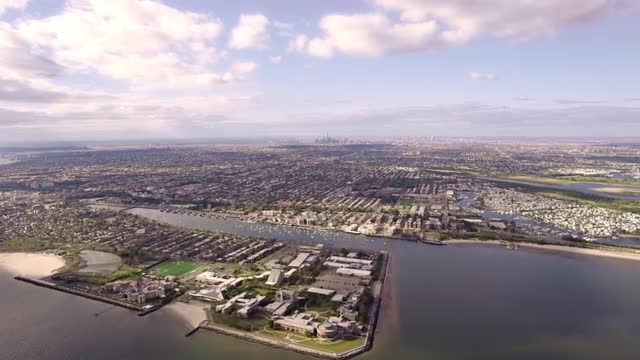 LONG AERIAL residential neighborhood of Manhattan Beach and busy Sheepshead Bay in Brooklyn