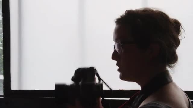 Female Photographer Silhouette against window