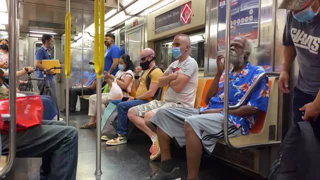 During Covid-19 passengers are uncomfortably close to each other while one man doesn’t wear a mask