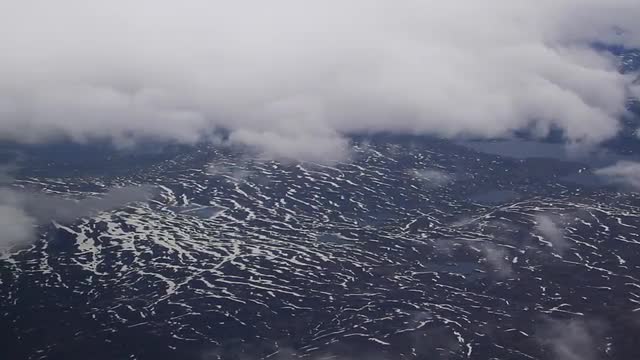 Flying through the clouds above the mountains of Norway