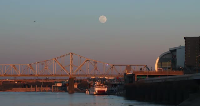 Bridges span the Ohio River near Louisville, Kentucky at dusk.