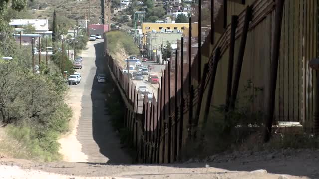 A large fence separates a border community.