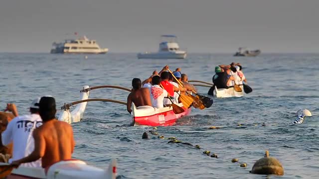 Slow motion of kayaks and outriggers in a race.