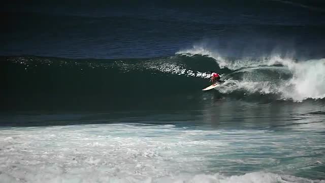 Surfer riding waves.