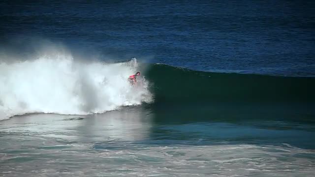 Surfer riding waves.