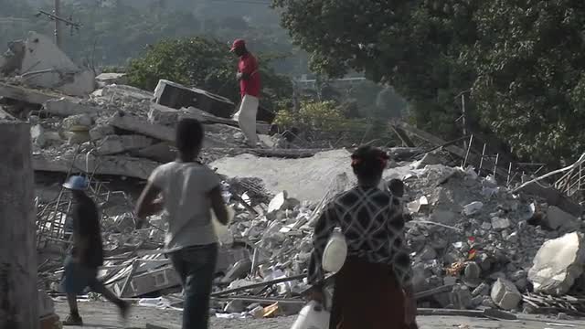 People sift through the rubble following the Haiti earthquake.