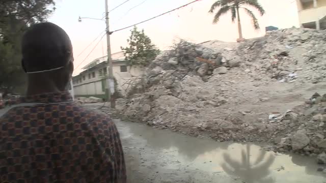 Medics stand amongst the rubble following the Haiti earthquake.