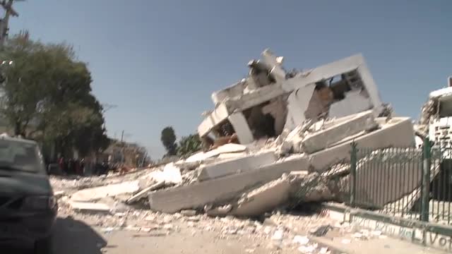 Pan to collapsed buildings following the Haiti earthquake.