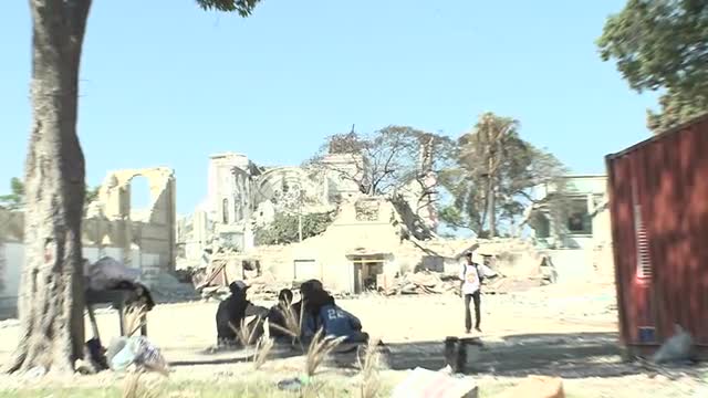 Women carry water through the rubble following the earthquake in Haiti.