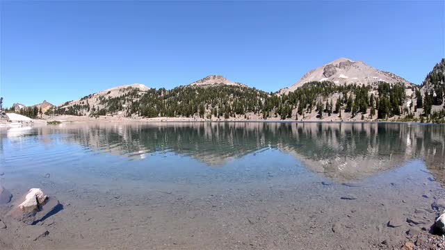 Clear blue water of Lake Helen below Eagle Peak in Lassen Volcanic National Park, California.