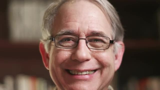 A older happy man talking over a video. Close up shot