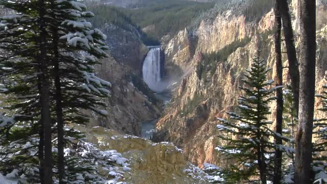 A waterfall cascades down the Grand Canyon of Yellowstone National Park.