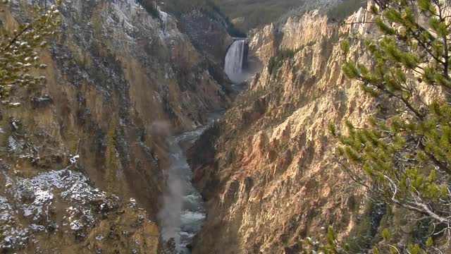 A waterfall flows down a mountainside in Yellowstone National Park.