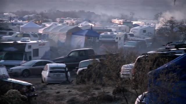 Smoke rises from fires at a campground.