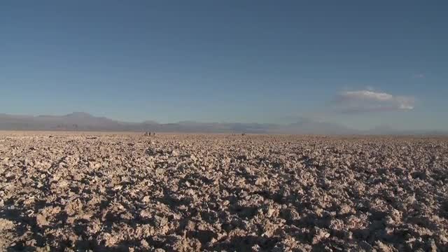 Vertical pan over the mineral formations at the Laguna Chaxa at the Salar de Atacama in the Reserva 