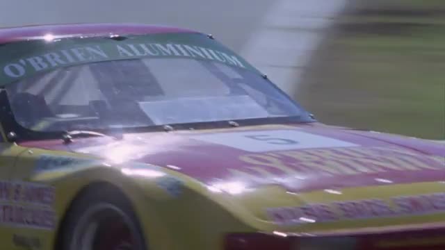 Racing cars competing on a circuit.