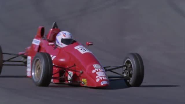 Formula cars competing on a circuit.