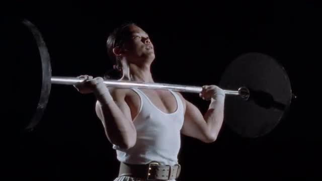 A man lifts weights.