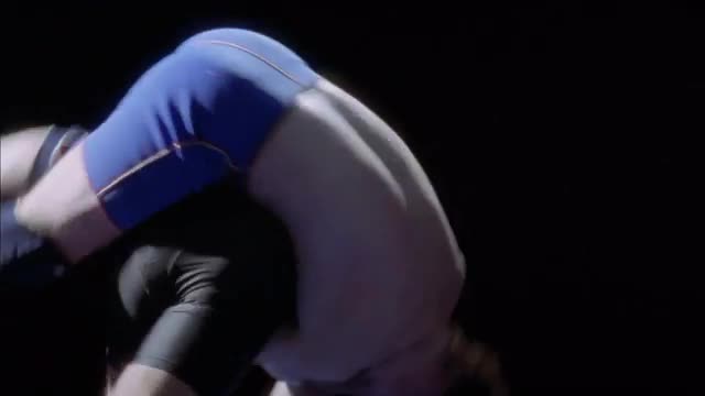 One man is taken down from a hip throw while wrestling.