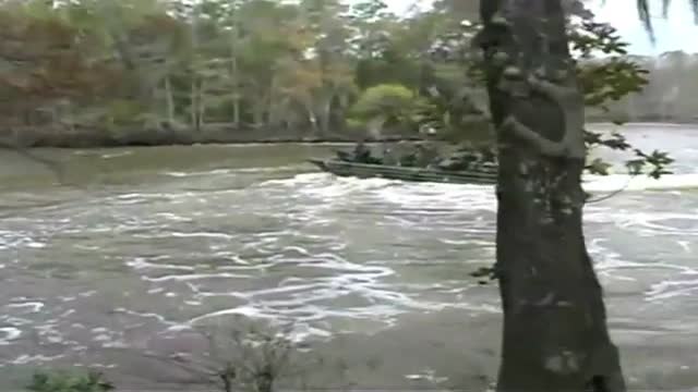 Navy SEALS special ops warcraft practice a river invasion exercise.