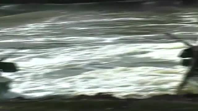 Navy SEALS special ops warcraft practice a river invasion exercise.