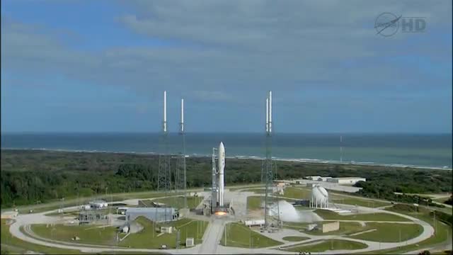 A NASA rocket launches from a launchpad.