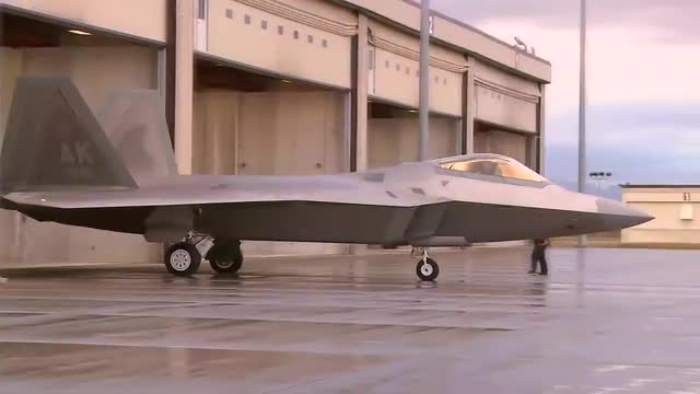 The F-22 Raptor rolls out of the hangar onto the runway.