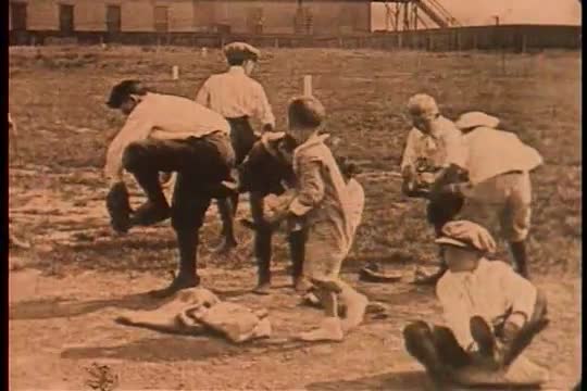 Boys get dressed for a baseball game in this 1928 shot.
