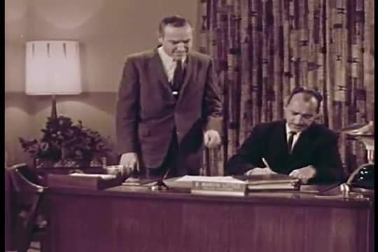 A satiric take on the process of industrial filmmaking in which miscommunication leads to an impossi