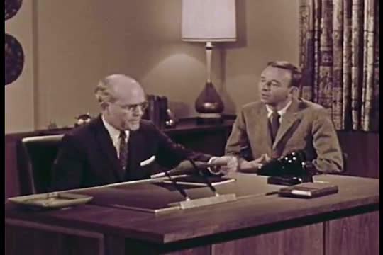 A satiric take on the process of industrial filmmaking in which miscommunication leads to an impossi