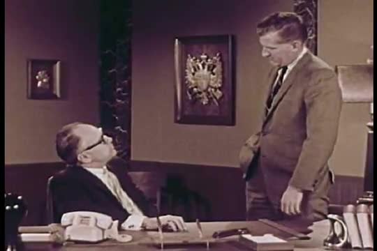 A satiric take on the process of industrial filmmaking in which miscommunication leads to an impossi