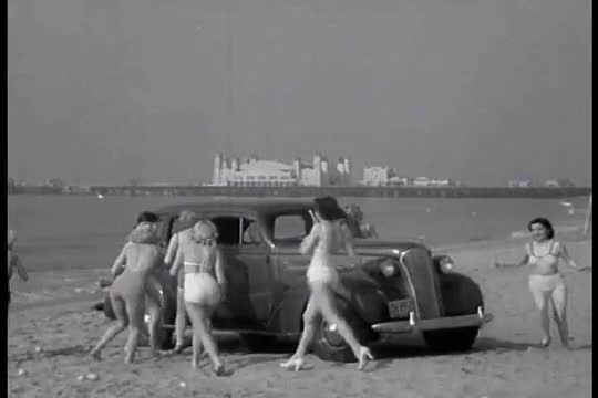 Chevrolet Leader News excerpt 1937. Bathing beauties throw baseballs at each other on the beach, the