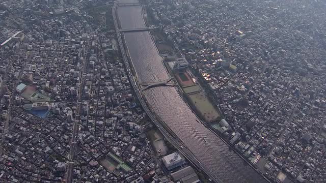 Aerial Sumida River bridges Tokyo city shipping barge Japan 