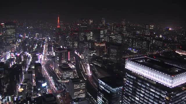Aerial Metropolis illuminated skyscrapers Tokyo Tower Business District Japan